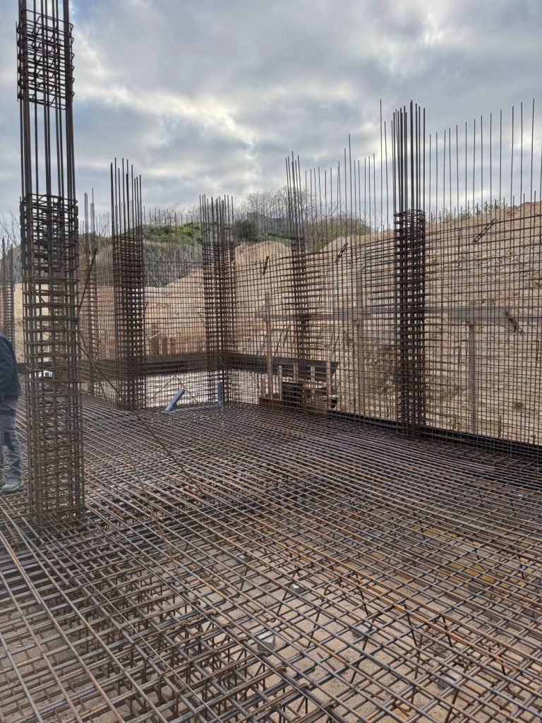 The raft foundation reinforcement, with the column cages.