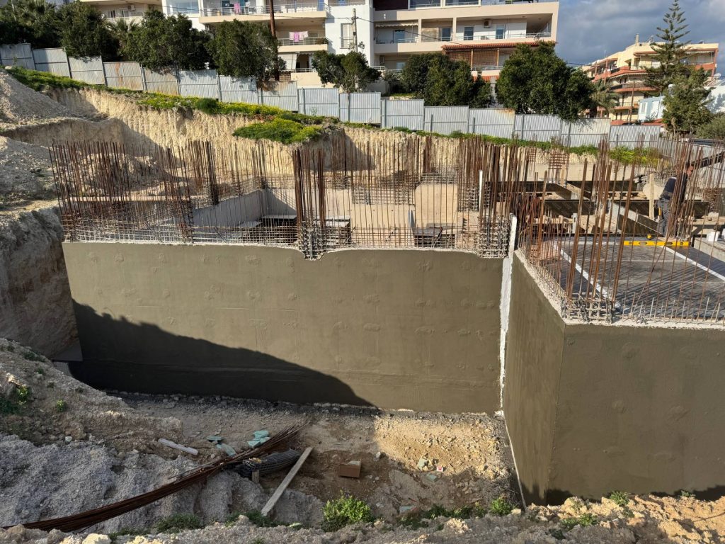 The basement walls after the concrete pour, with the waterproof coating.