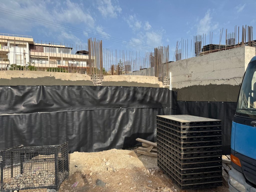 Drainage membrane on the basement walls, with the steel formwork panels in the foreground.
