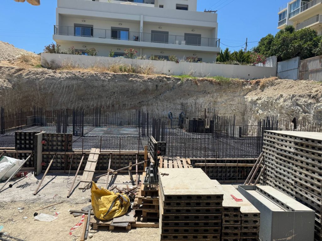 The foundation formwork for the next building, beside the neighbouring houses.