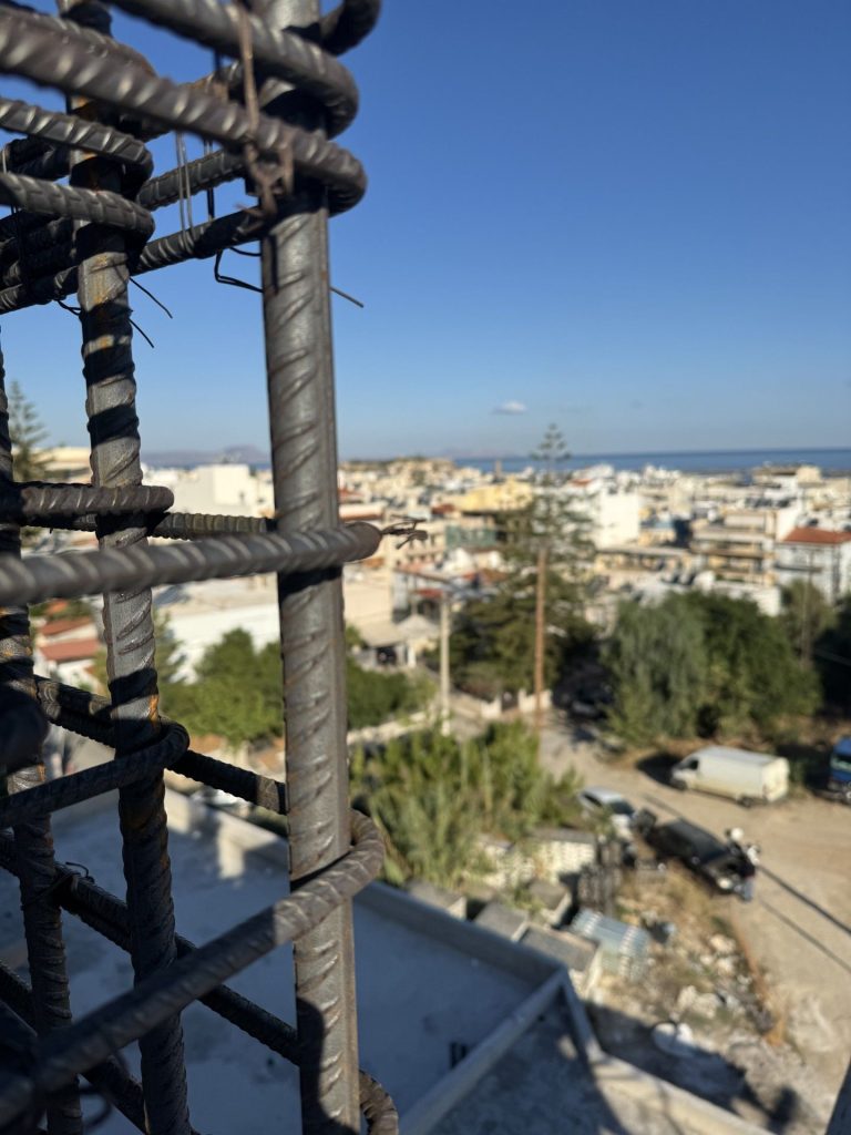 Column reinforcement, with the town and the sea in the background.