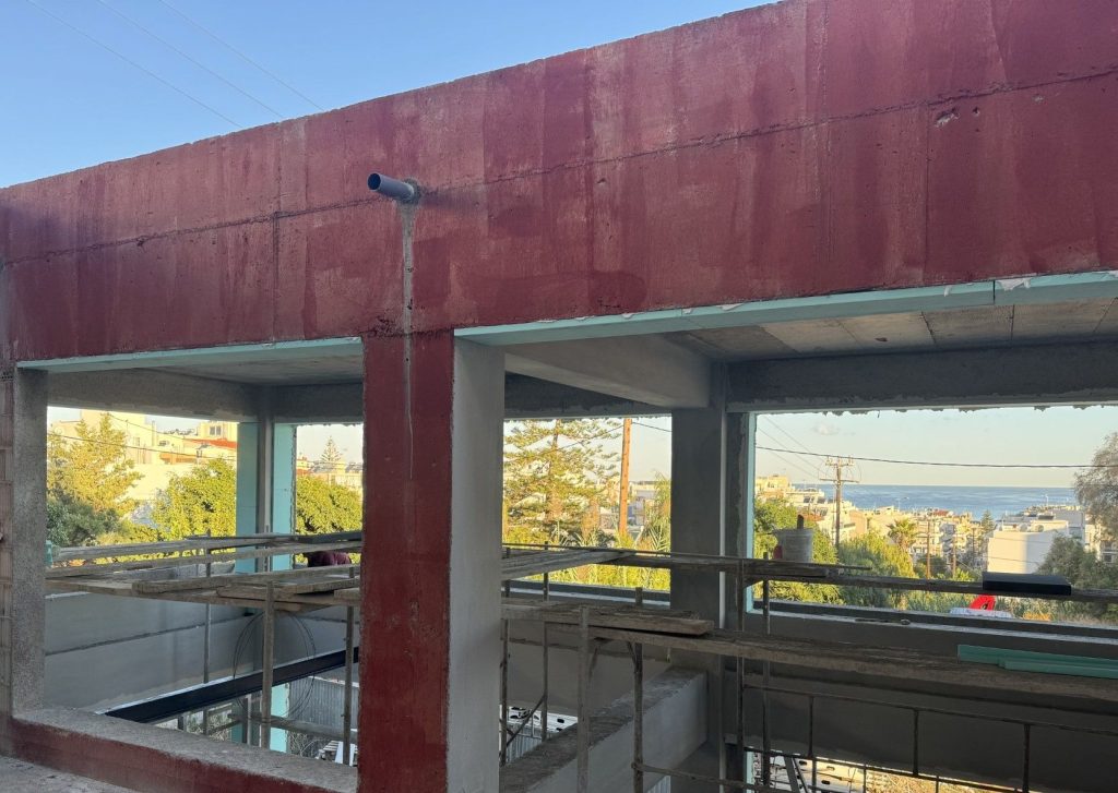 The load-bearing structure of an upper floor, with a view over the town and the sea.