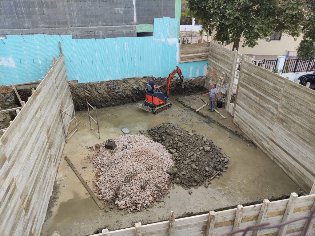 Spreading gravel at the bottom of the pit, with the excavator in the background.