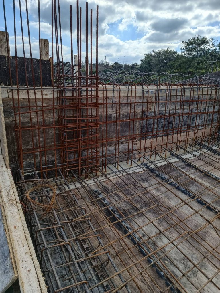 The reinforcement for the upper-floor slab and the perimeter beam.