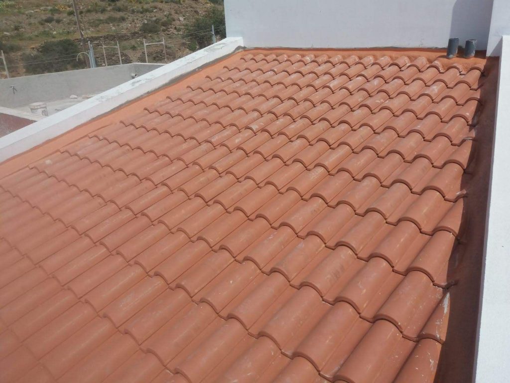 The tiled roof between the roof terrace parapets.