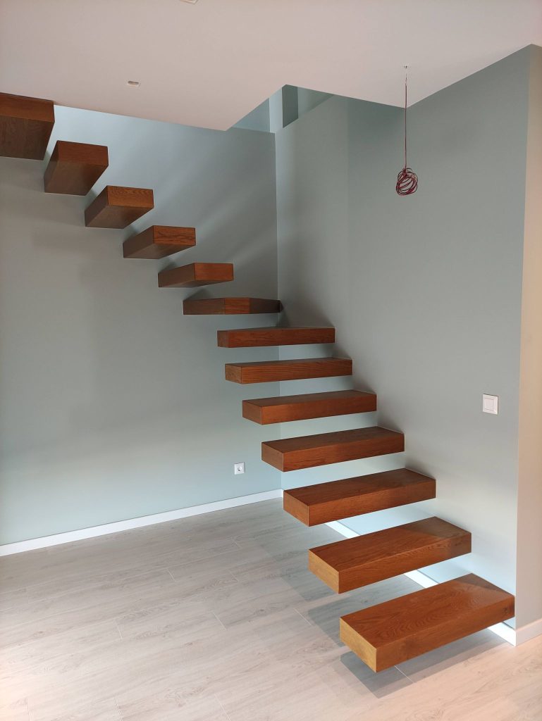 An interior staircase with floating timber treads.