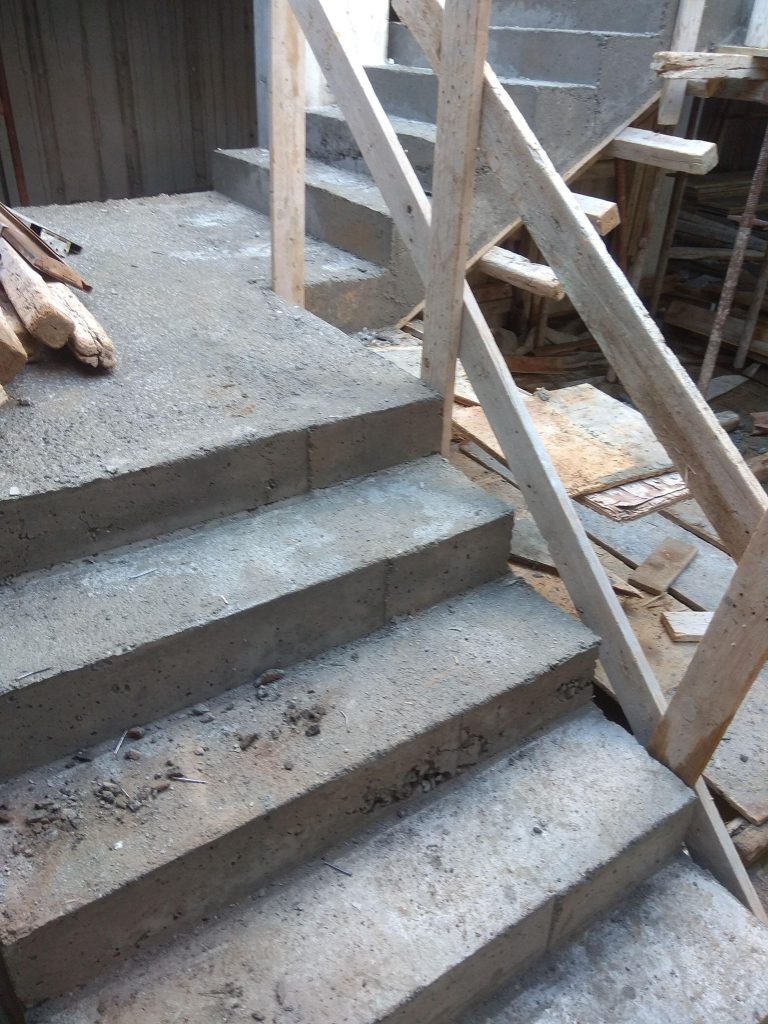The reinforced concrete staircase after the formwork was removed, with the props still in place.