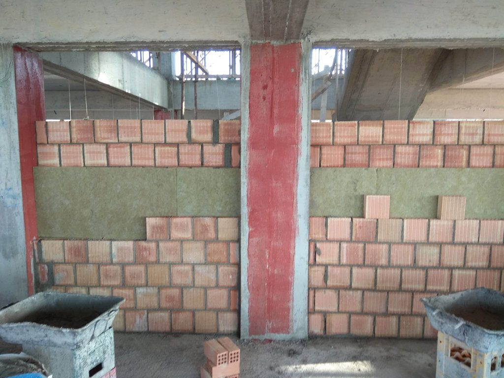 A double masonry wall with rock wool insulation between the two leaves.