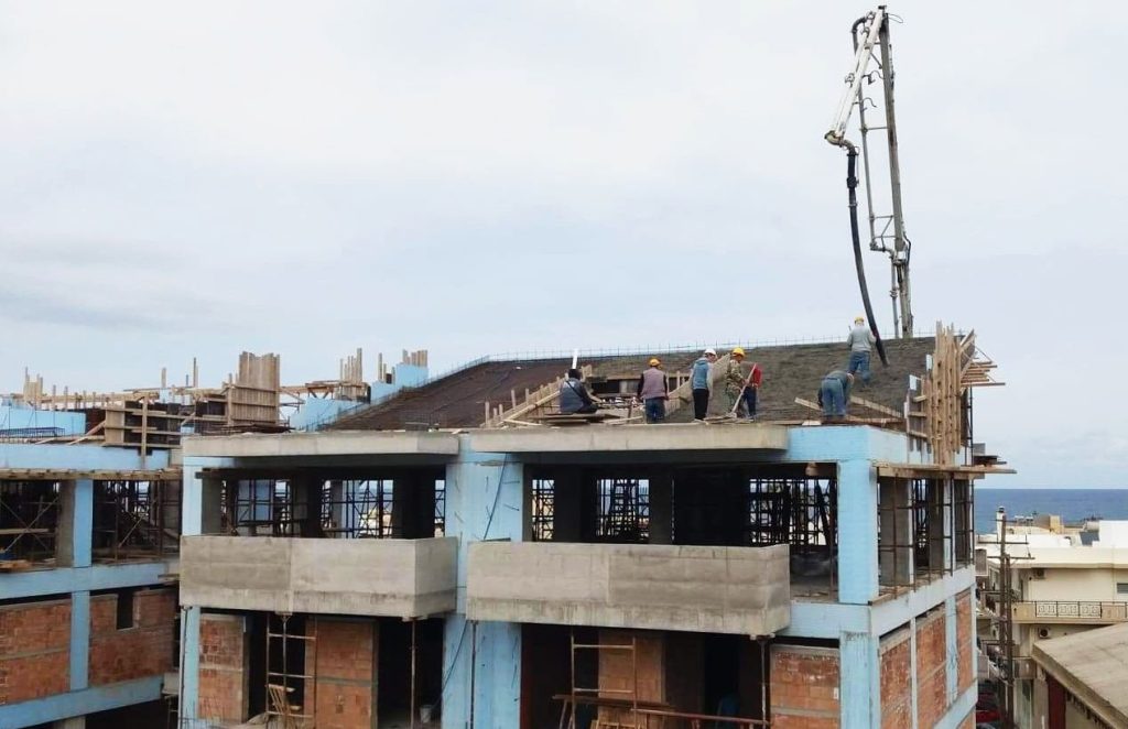 Pouring the roof slab with a pump, with the sea in the background.