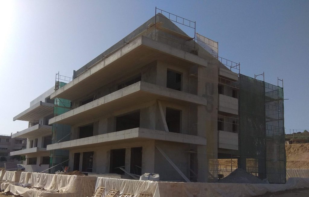The building plastered, with scaffolding on the façades.