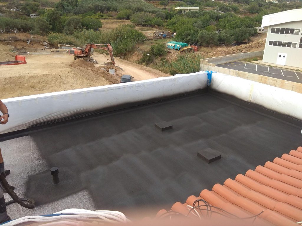 Waterproofing the roof terrace, with the building site around it.