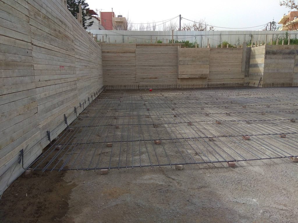 Placing the raft foundation reinforcement next to the wall formwork.