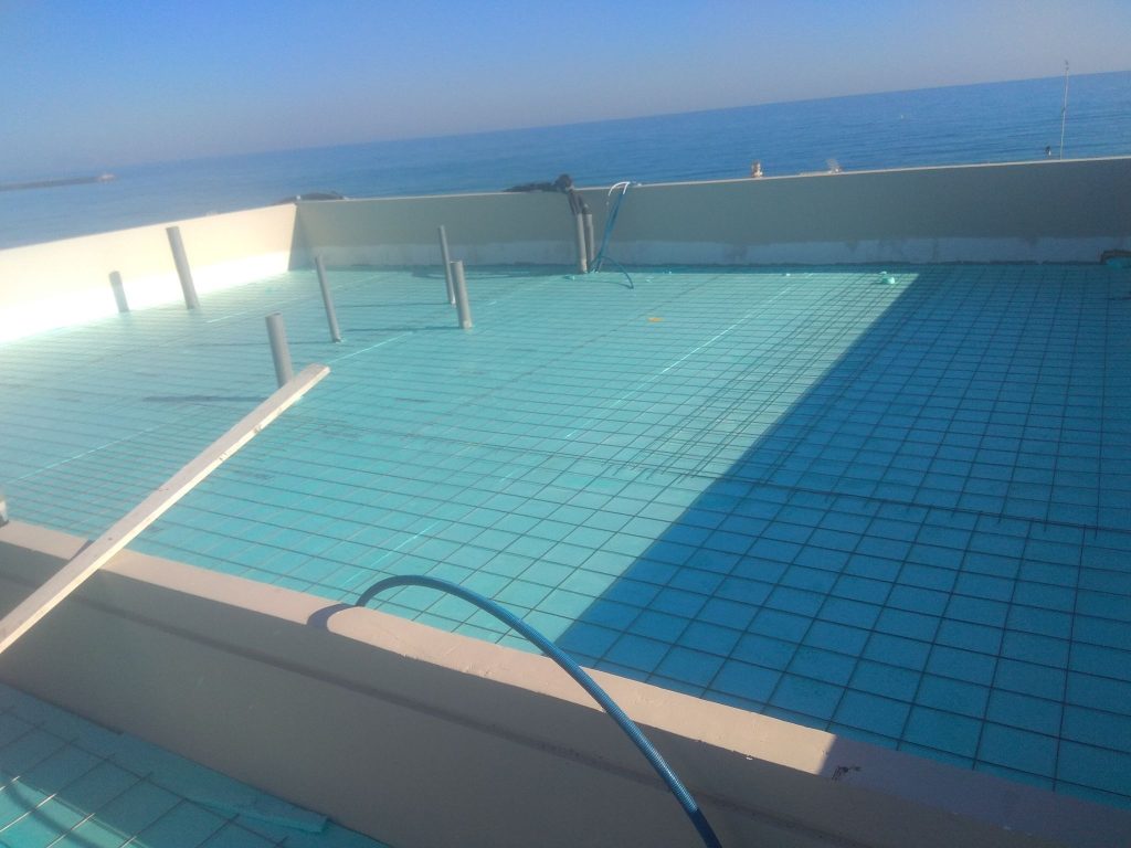 Lining the pool with mosaic tiles, with the sea in the background.