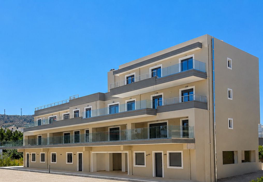 The long side of the building, with glass-railed balconies on every floor.