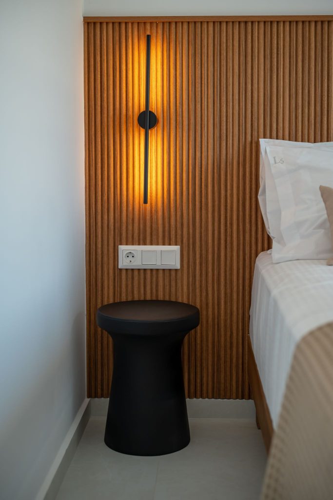 Detail of the timber cladding, with the wall light beside the bed.
