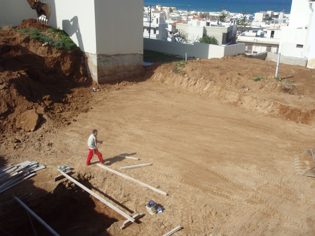 The plot after excavation, while the foundations are being set out.