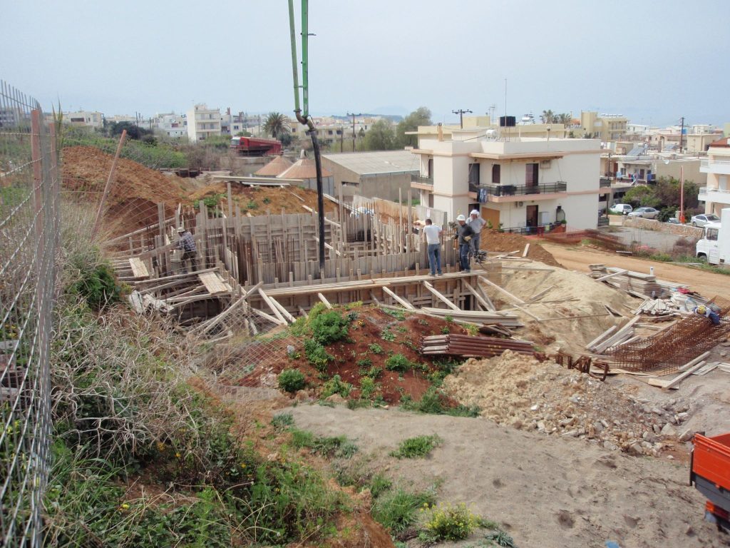 Pouring concrete into the basement with a pump, from the upper part of the plot.