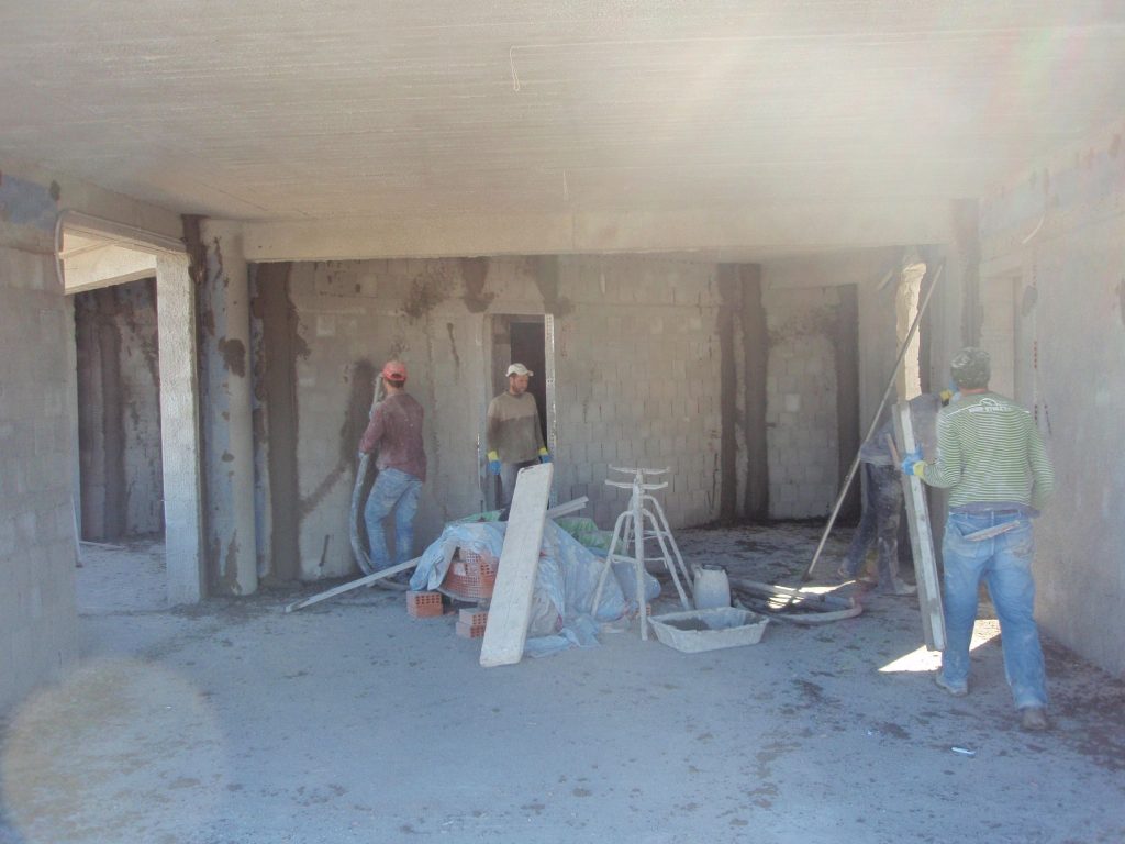 A crew plastering the interior.
