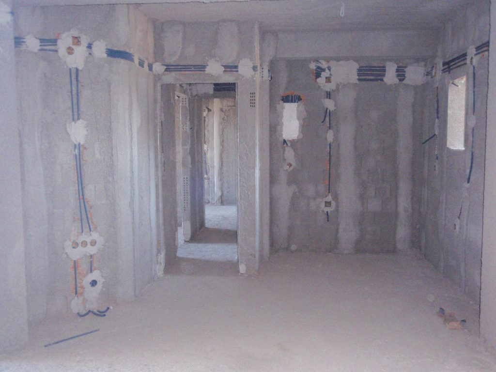 An interior with the electrical conduits and junction boxes, before the final plastering.