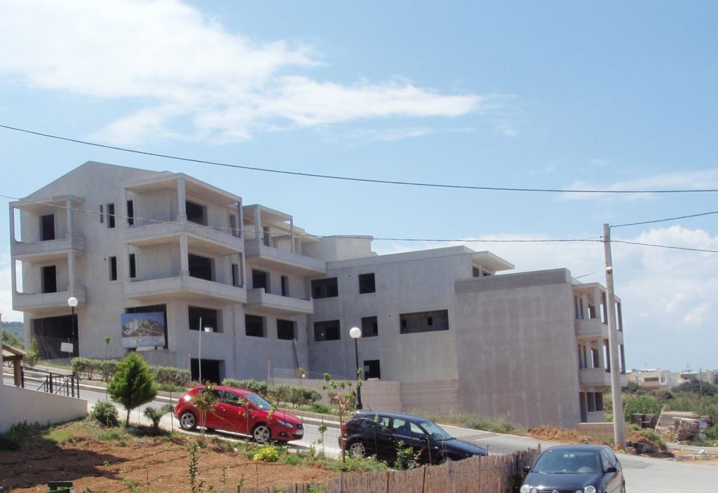The complex from the street, with plastering of the façades under way.
