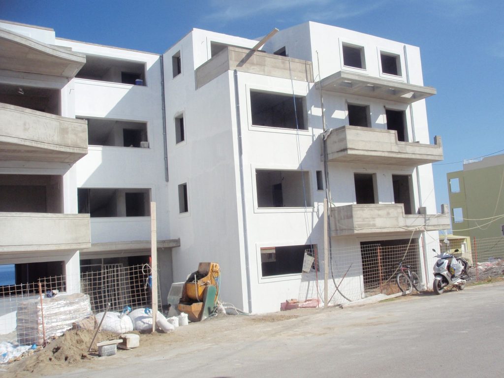 The building from the street, with the plastering complete and the openings still without windows and doors.