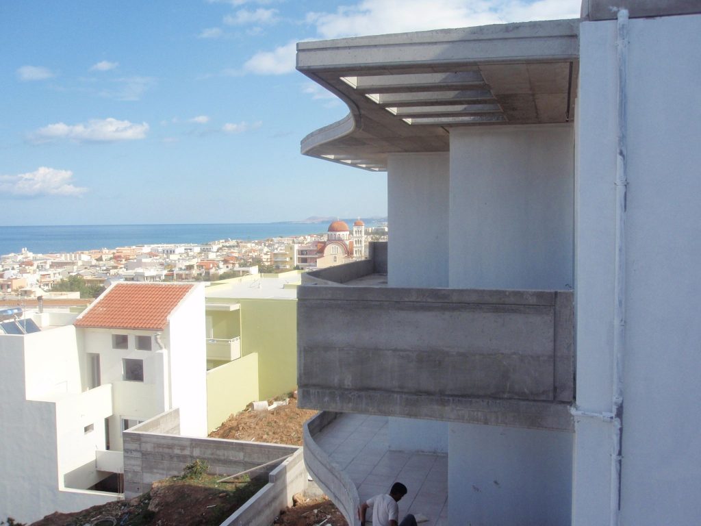 The view from a top-floor balcony over the town and the sea.