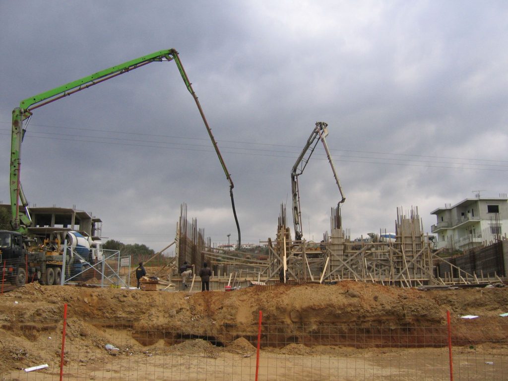 Two concrete pumps on site, in the early stages of the load-bearing structure.