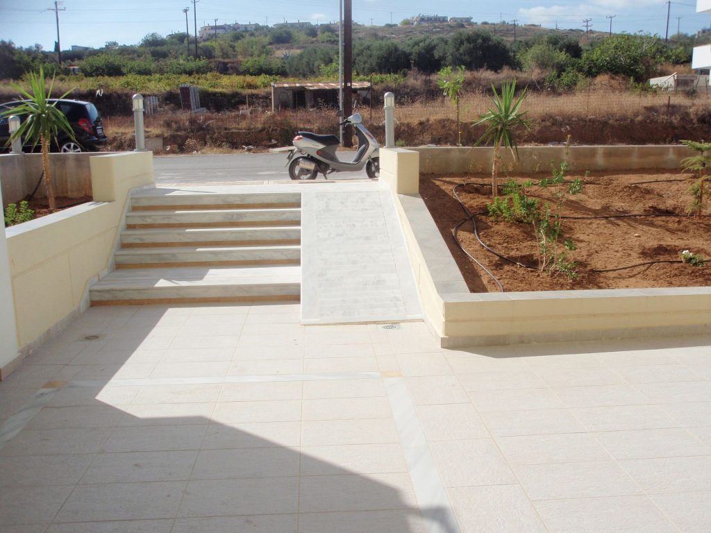 The entrance steps and ramp, with the flower beds planted shortly after handover.
