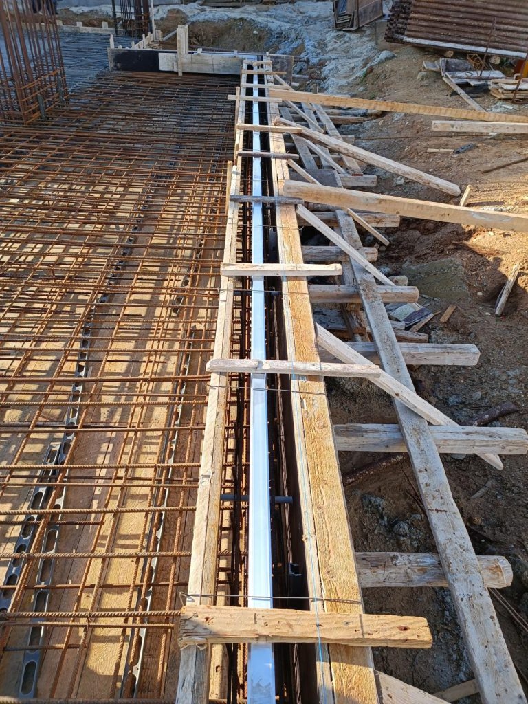 Beam reinforcement inside the formwork, with the props alongside.