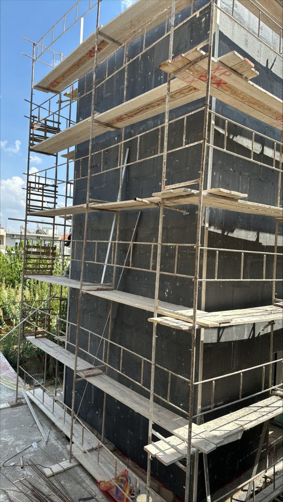 External thermal insulation on the façades, behind the scaffolding.