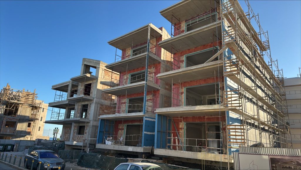 The buildings from the street corner, with the balconies and scaffolding.