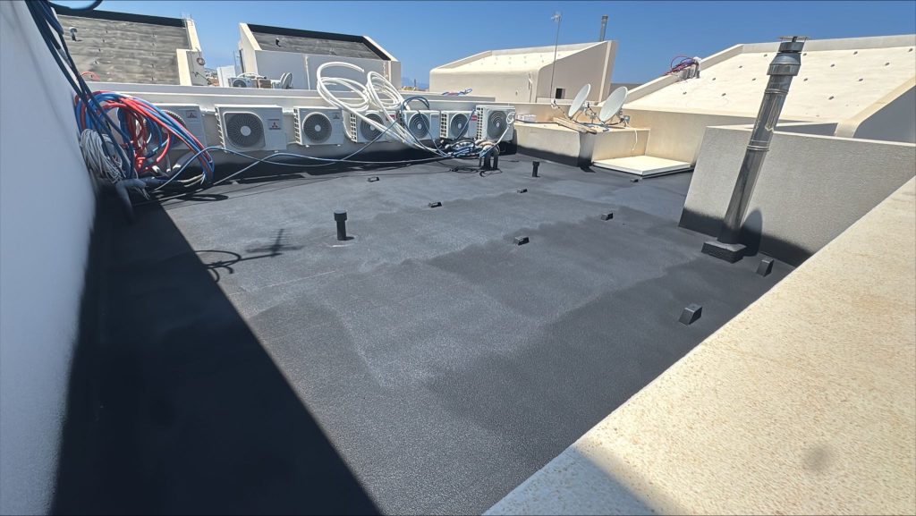 The heat pump outdoor units on the roof terrace, after waterproofing.