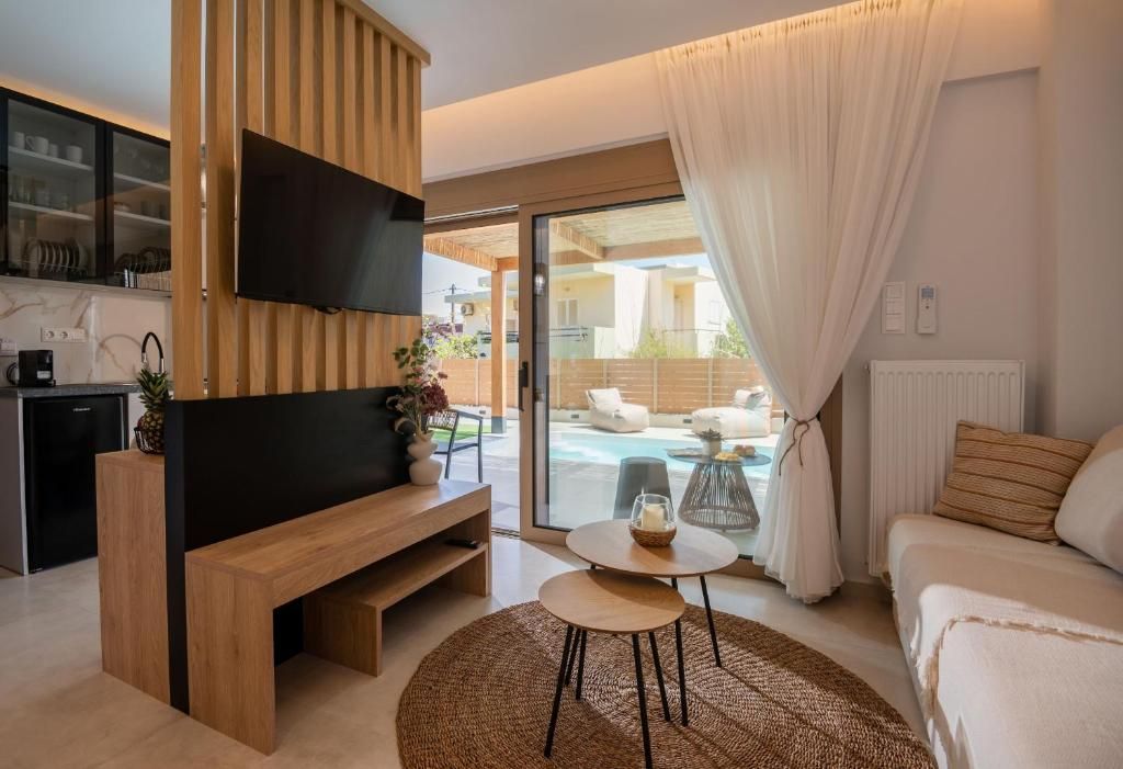 A living room with a wooden partition and sliding glass doors to the pool.