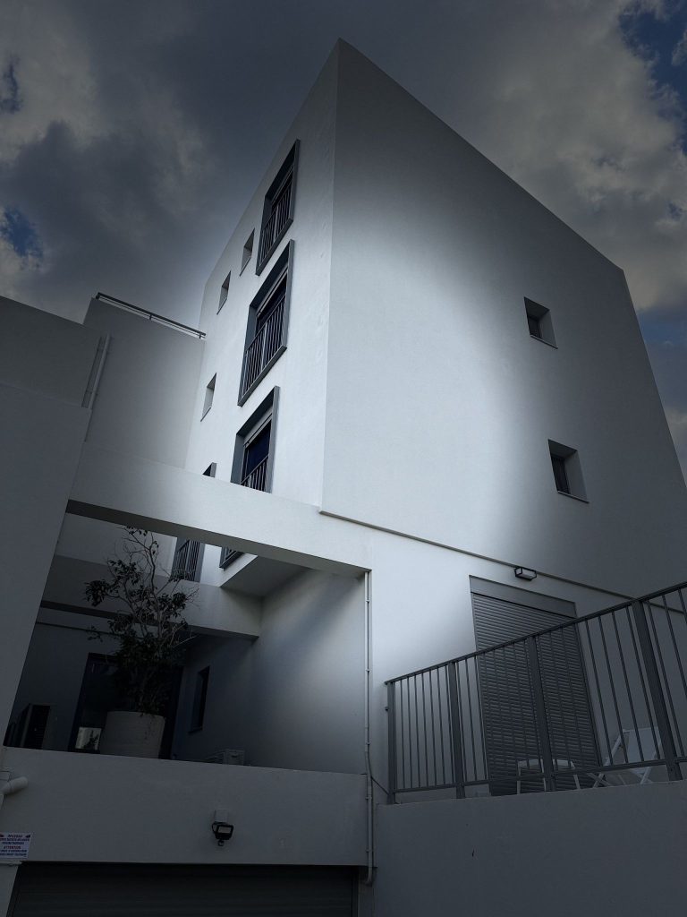 The corner of the building from below, with the stairwell windows.