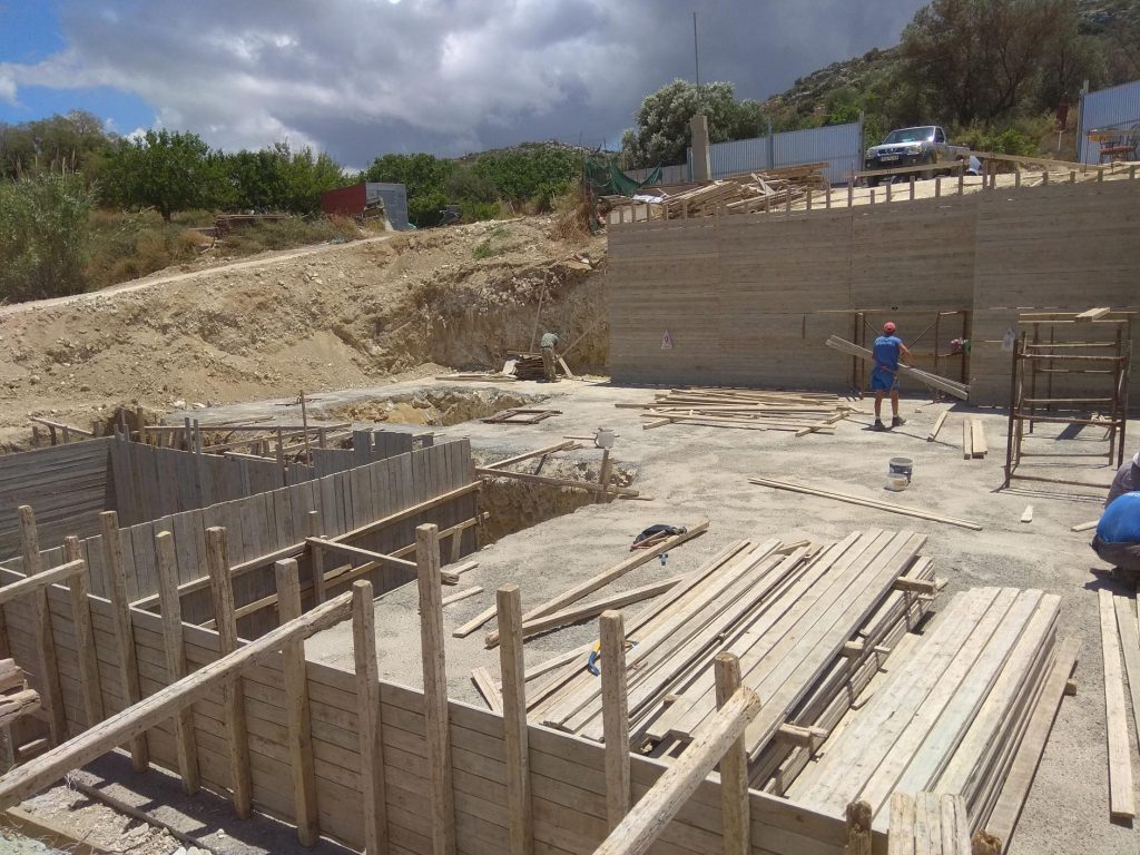 The foundation formwork in the pit, with the crew at work.