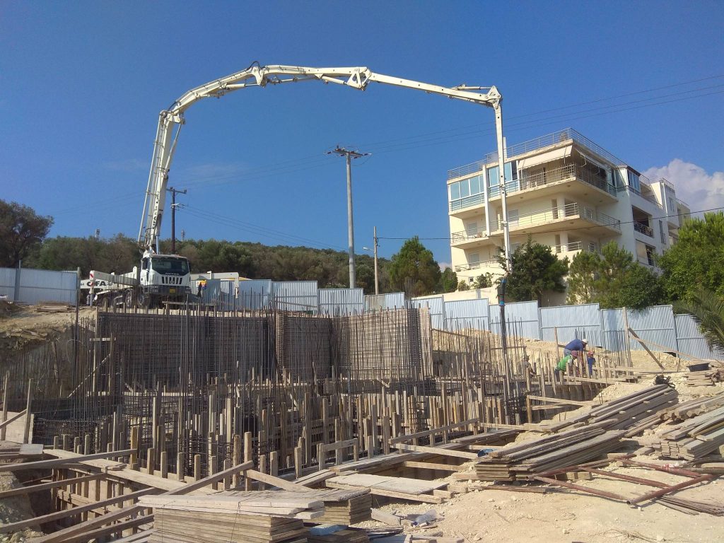 Pouring the foundation with a concrete pump.