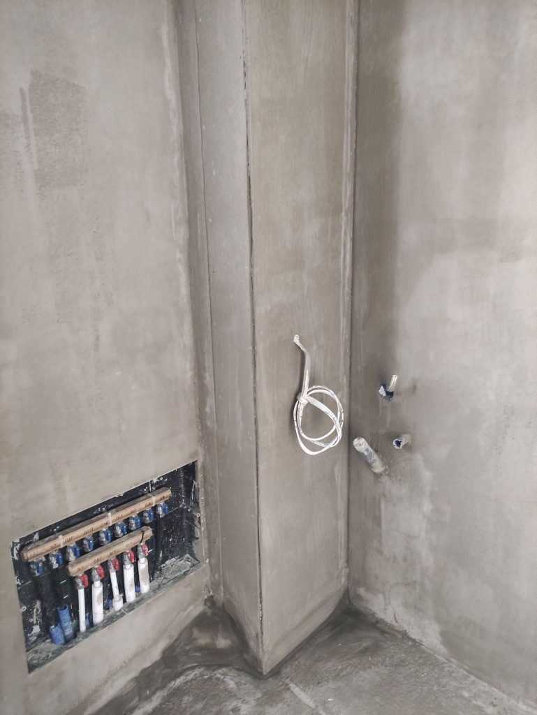 The water supply manifold in the floor, before the floor finishes.